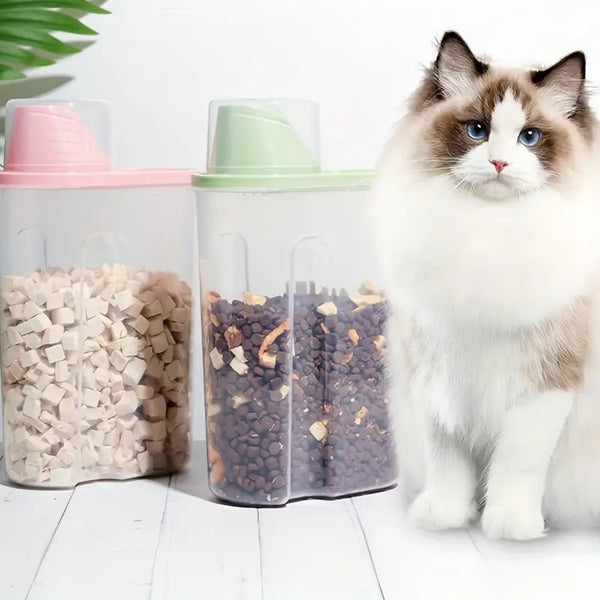 Ragdoll cat sitting beside two Stow Airtight Food Bucket containers filled with kibble, pink and green lids