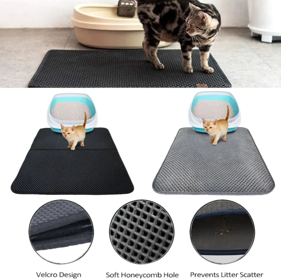 A cat walking across the black Terrace mat in front of a litter tray on a wooden floor