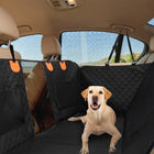 Bench Dog Back Seat Cover fitted in a car rear seat, quilted black panels with orange headrest straps and a Labrador on the bench