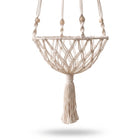 Drift Macrame Cat Hammock shown from a three-quarter rear angle, ivory cotton rope diamond-weave basket with wood beads and tassel, on white studio background