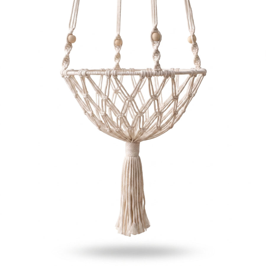Drift Macrame Cat Hammock shown from a three-quarter rear angle, ivory cotton rope diamond-weave basket with wood beads and tassel, on white studio background
