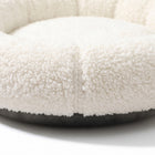 Close-up detail of the Halo Round Cushion Bed plush sherpa fleece texture and stitched seam