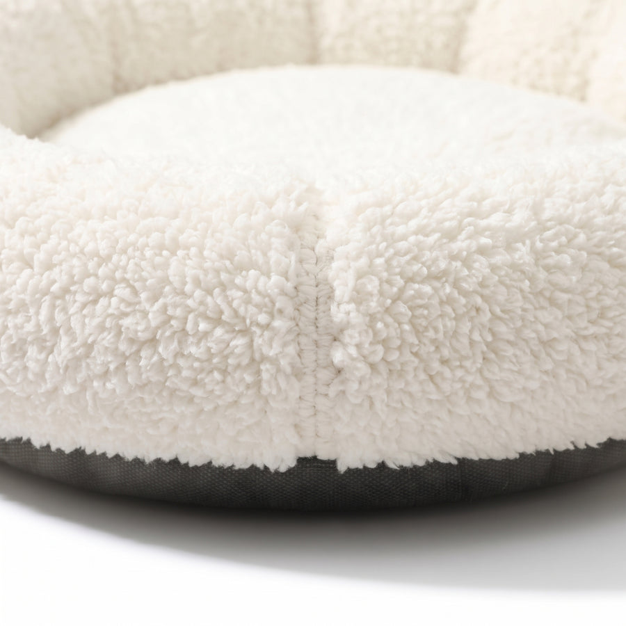 Close-up detail of the Halo Round Cushion Bed plush sherpa fleece texture and stitched seam