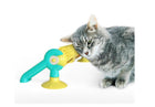 Cat rubbing its cheek along the Loop track bristles, toy standing on its suction feet