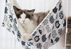 Ledge hammock double-sided detail: soft sherpa lining on the reverse, cat nestled in the cream cat-print side
