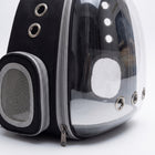 Close-up detail of the Vista Clear Cat Backpack showing the clear bubble dome seam, silver grommet air vents, and zipper stitching on the black and grey carrier shell